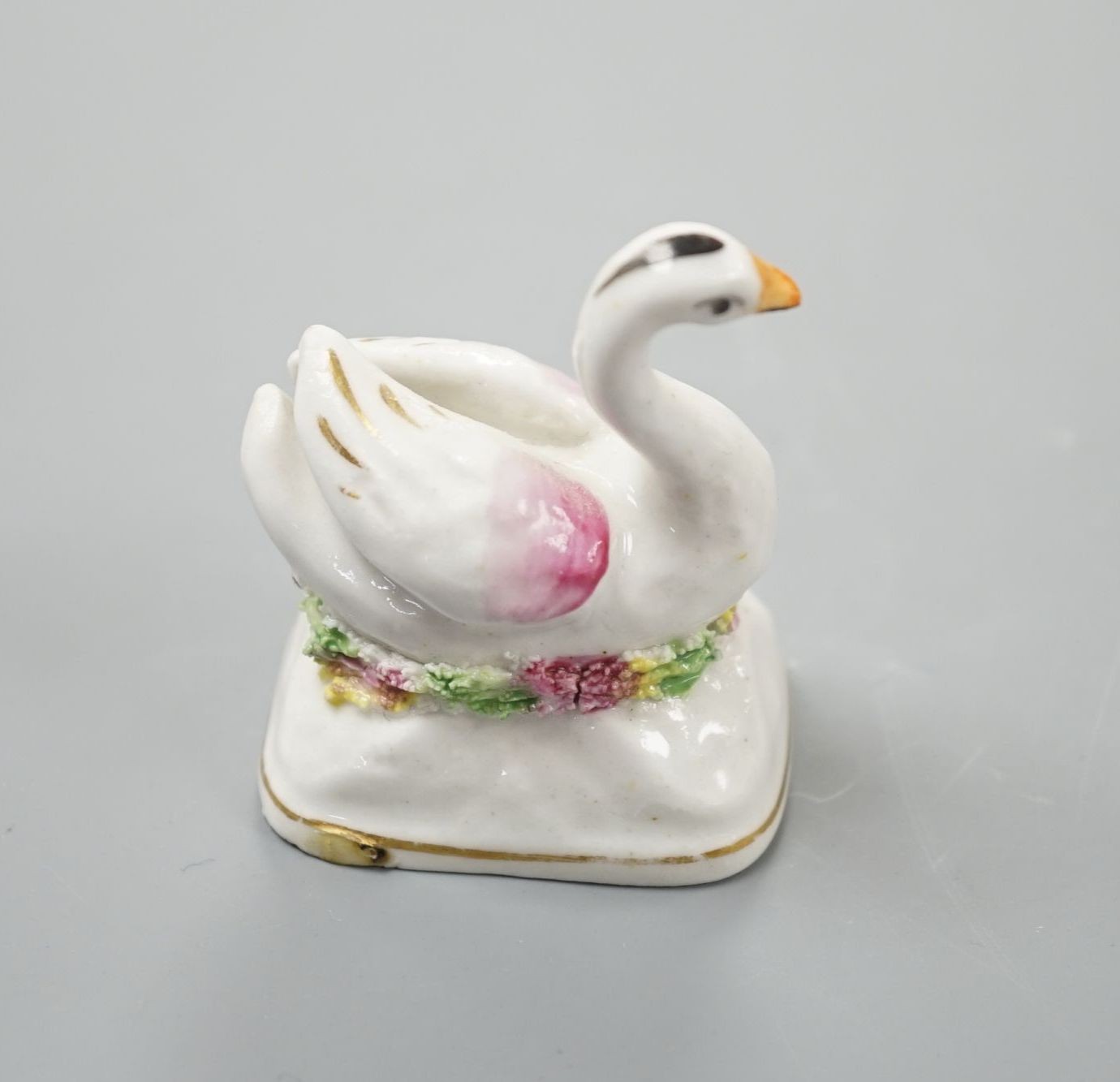 A Staffordshire porcelain model of a swan, c.1835-50, on a mound base, 5.4 cm high, Provenance: Dennis G.Rice collection